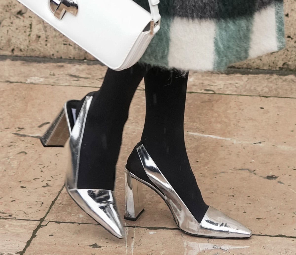 Kelly Rutherford shines in her metallic silver Patou pumps featuring pointed toes, squared vamps, thick slingback straps, and wide block heels
