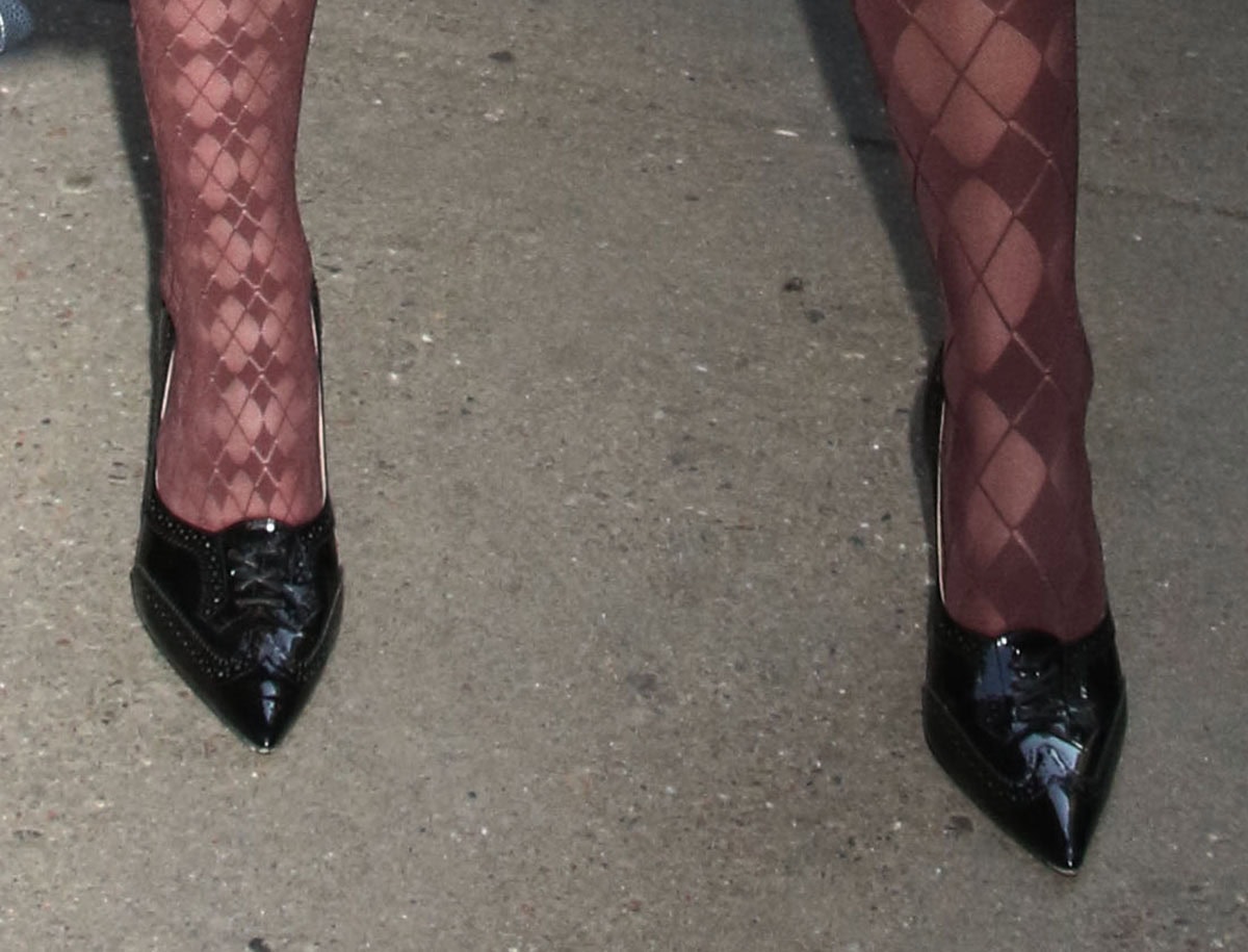 Kiernan Shipka completes her Thom Browne look with the burgundy “Funmix Argyle” sheer tights and a pair of black brogue-style pumps