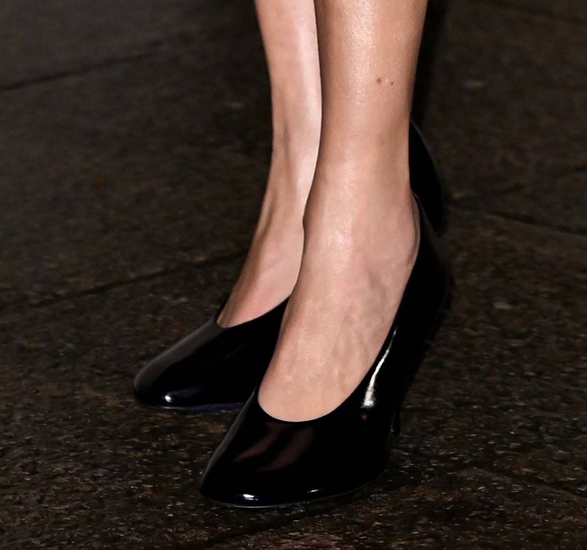 Alexa Chung slips into a glossy pair of black patent leather glove pumps