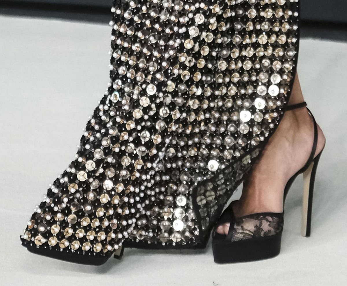 Halle Berry goes sultry from the ground up, slipping her feet into a pair of see-through floral lace sandals by Andrea Wazen