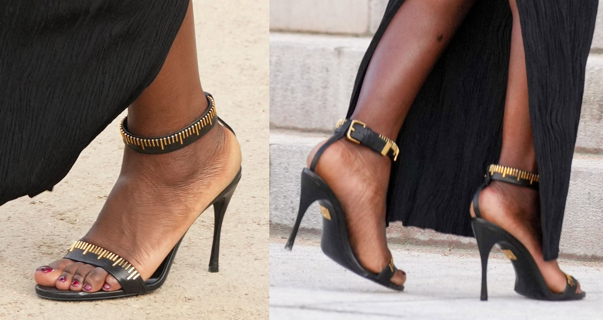 Jodie Turner-Smith shows off her red pedicure in the black Schiaparelli Measuring Tape sandals featuring the house's signature brass tape-measure design