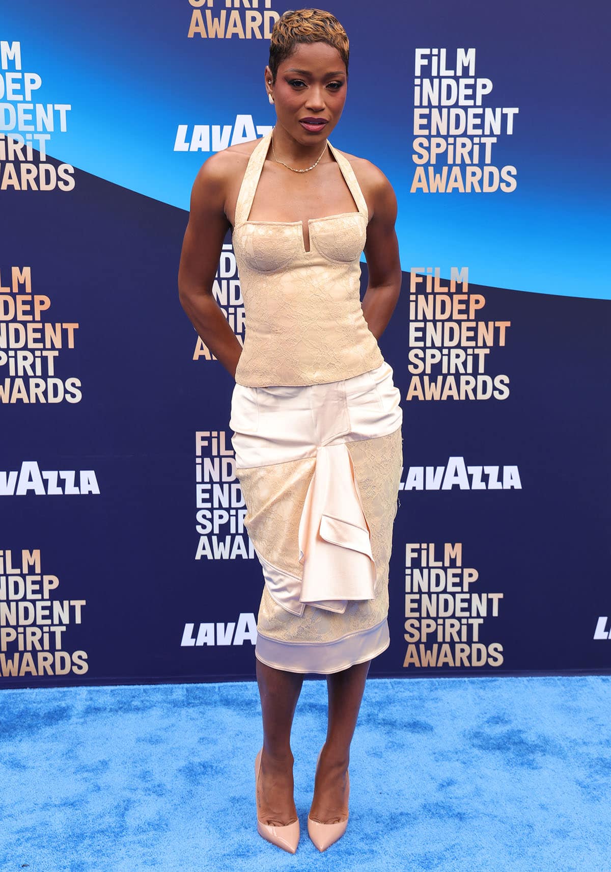Keke Palmer continues with her timeless look by pairing her pumps with an archival Dior Spring 2004 floral jacquard halter top and a matching deconstructed pencil skirt