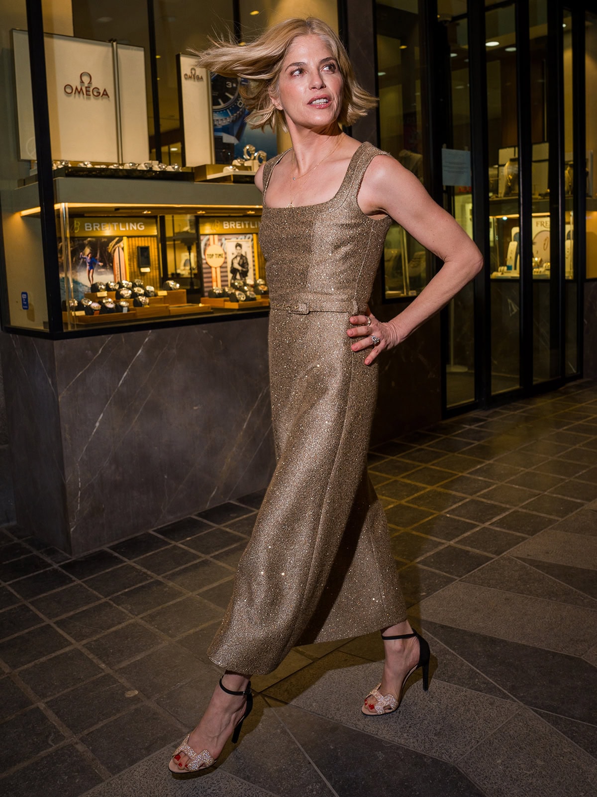 Selma Blair pairs her crystal Hermes sandals with a shimmering gold Emilia Wickstead dress
