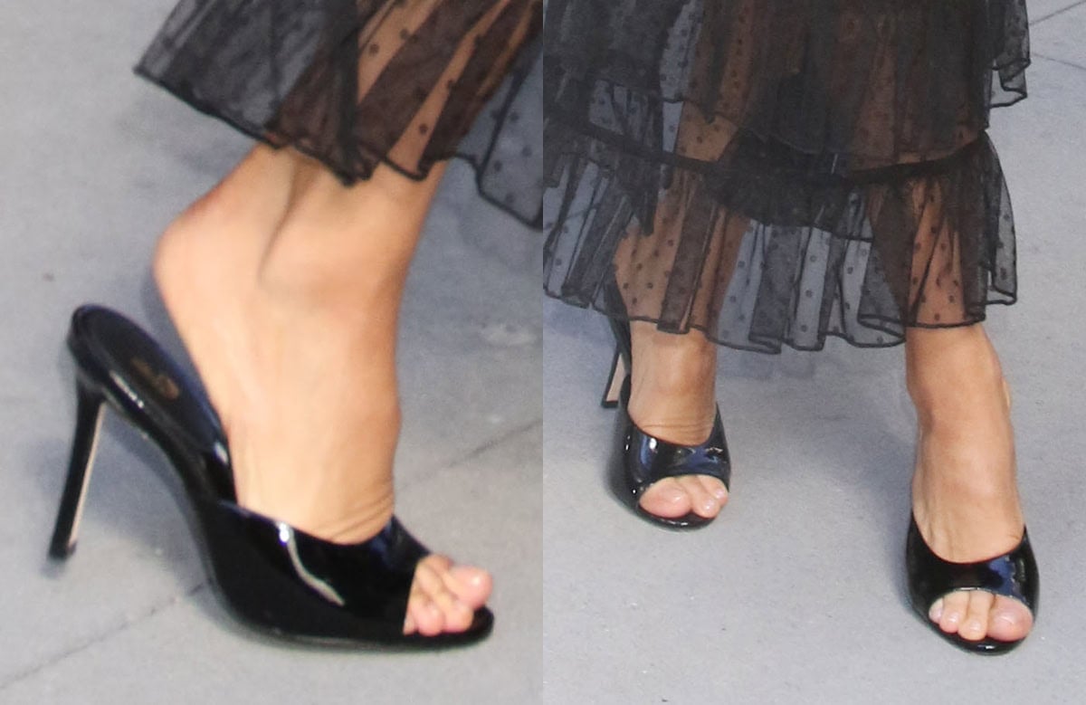 Jenna Dewan slips into a pair of shiny black patent mules with open toes, an open back, and stiletto heels