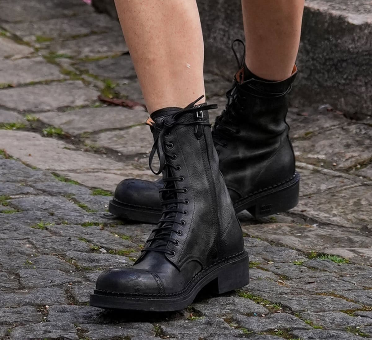Poppy Delevingne balances feminine allure with modern edge with her Miu Miu pebbled leather lace-up boots