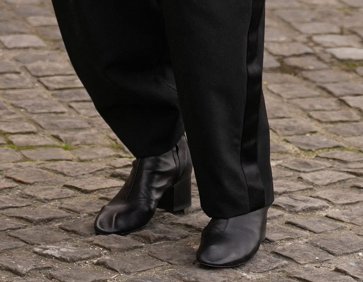 Sarah Paulson wears the black Celine “Cheri” ankle boots featuring square block heels, almond toes, and visible stitching