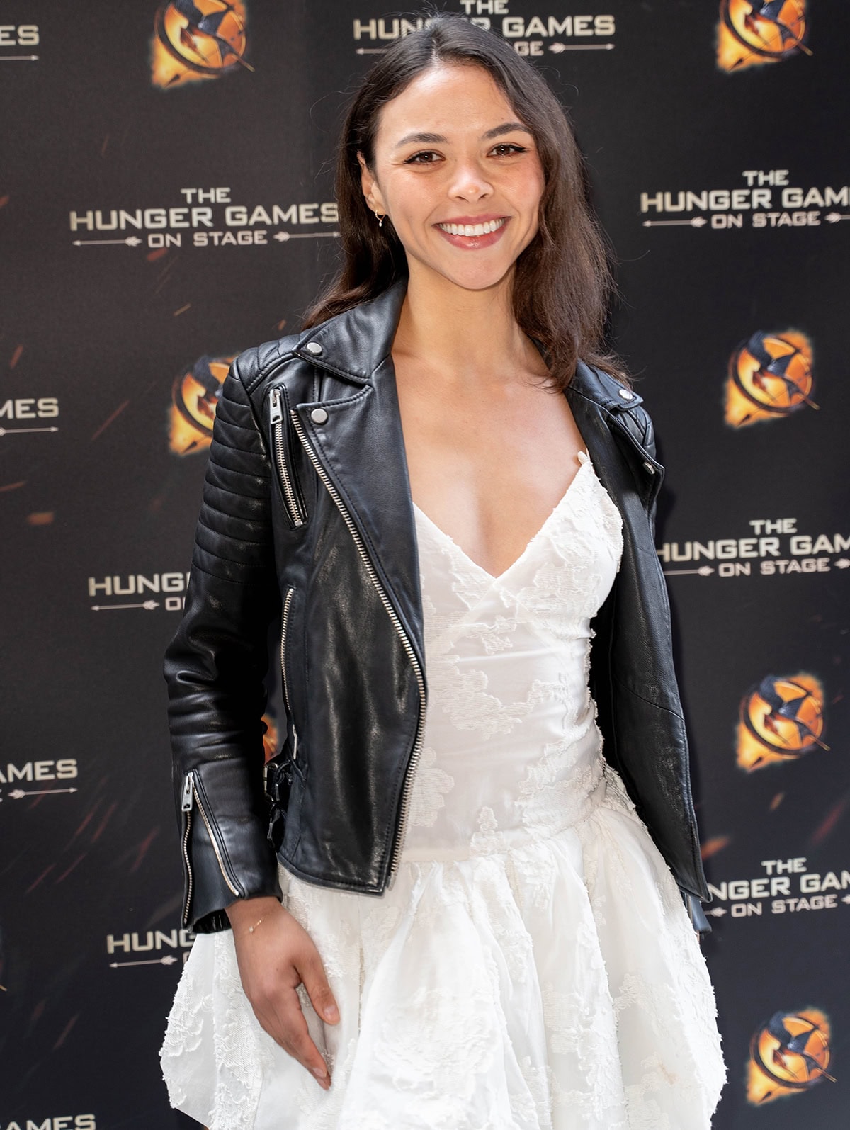 Vanessa Bauer pairs her black knee-high boots with a black moto jacket and a white lace Mango mini dress