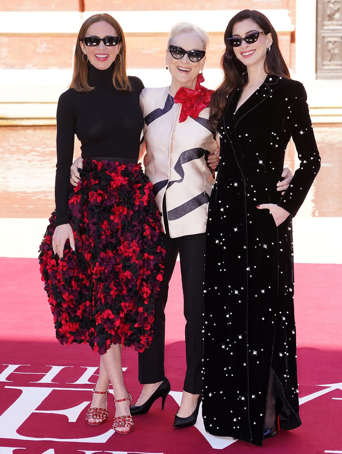 Emily Blunt, Meryl Streep, and Anne Hathaway attend The Devil Wears Prada 2 photocall in black and red looks with matching black pumps and red heels at the VA in central London