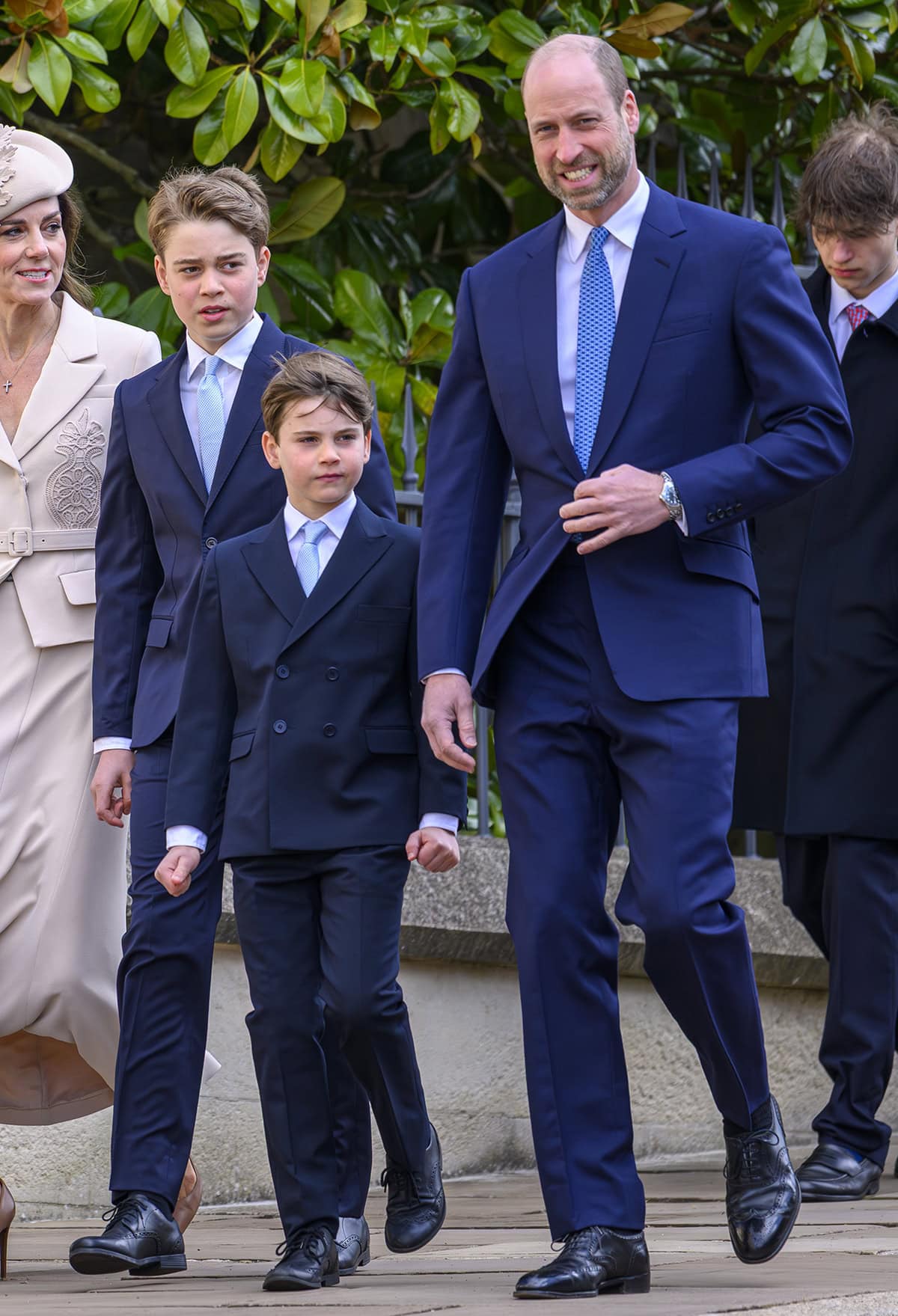 Prince William, Prince George, and Prince Louis step out in coordinated navy tailoring, grounding their polished Easter looks with classic black Oxford shoes that keep the focus sharp and timeless