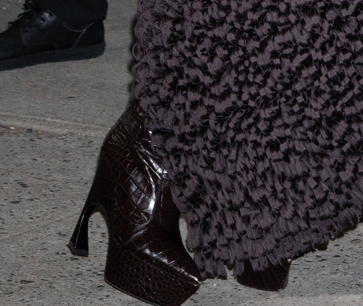 Teyana Taylor brings an edge to the event with her Bordeaux croc-effect leather boots by Victoria Beckham with sharp pointed toes, platforms, and sculptural curved heels