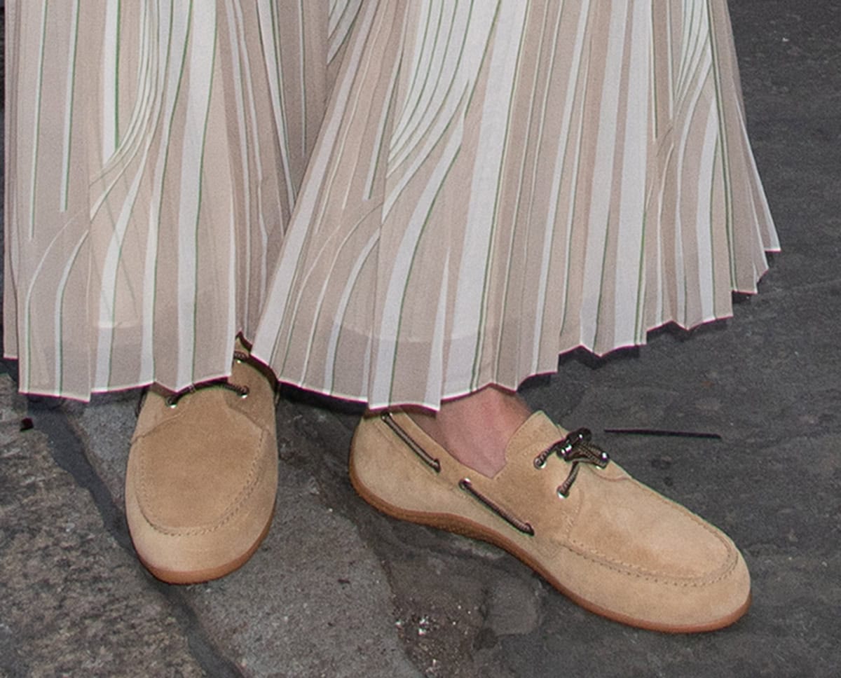 Ashley Benson wears Longchamp's “Longboat” shoes in beige suede with black laces along the top