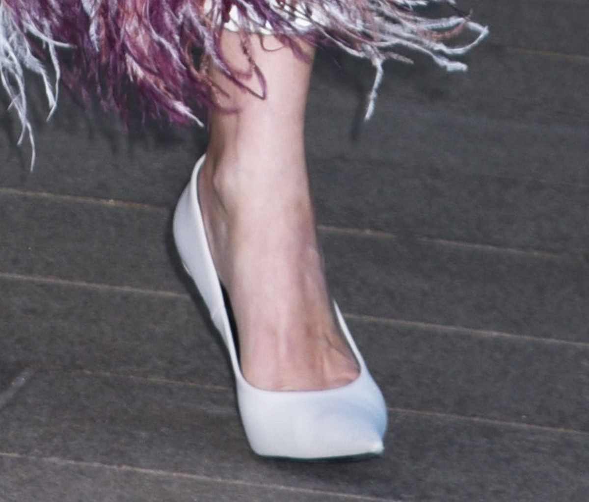Diane Kruger slips into a basic pair of white leather pumps with pointed toes and stiletto heels
