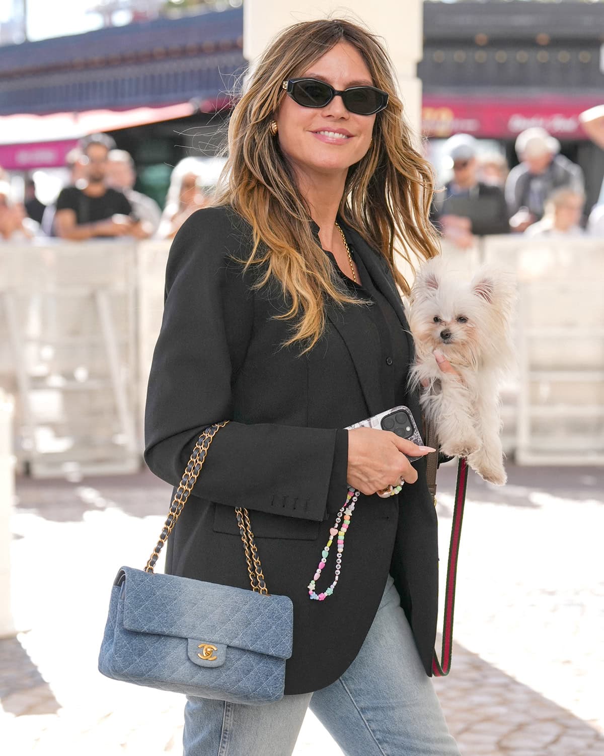 Heidi Klum carries her dog Fritz in one hand and her Chanel 11.12 Bag in washed denim in the other