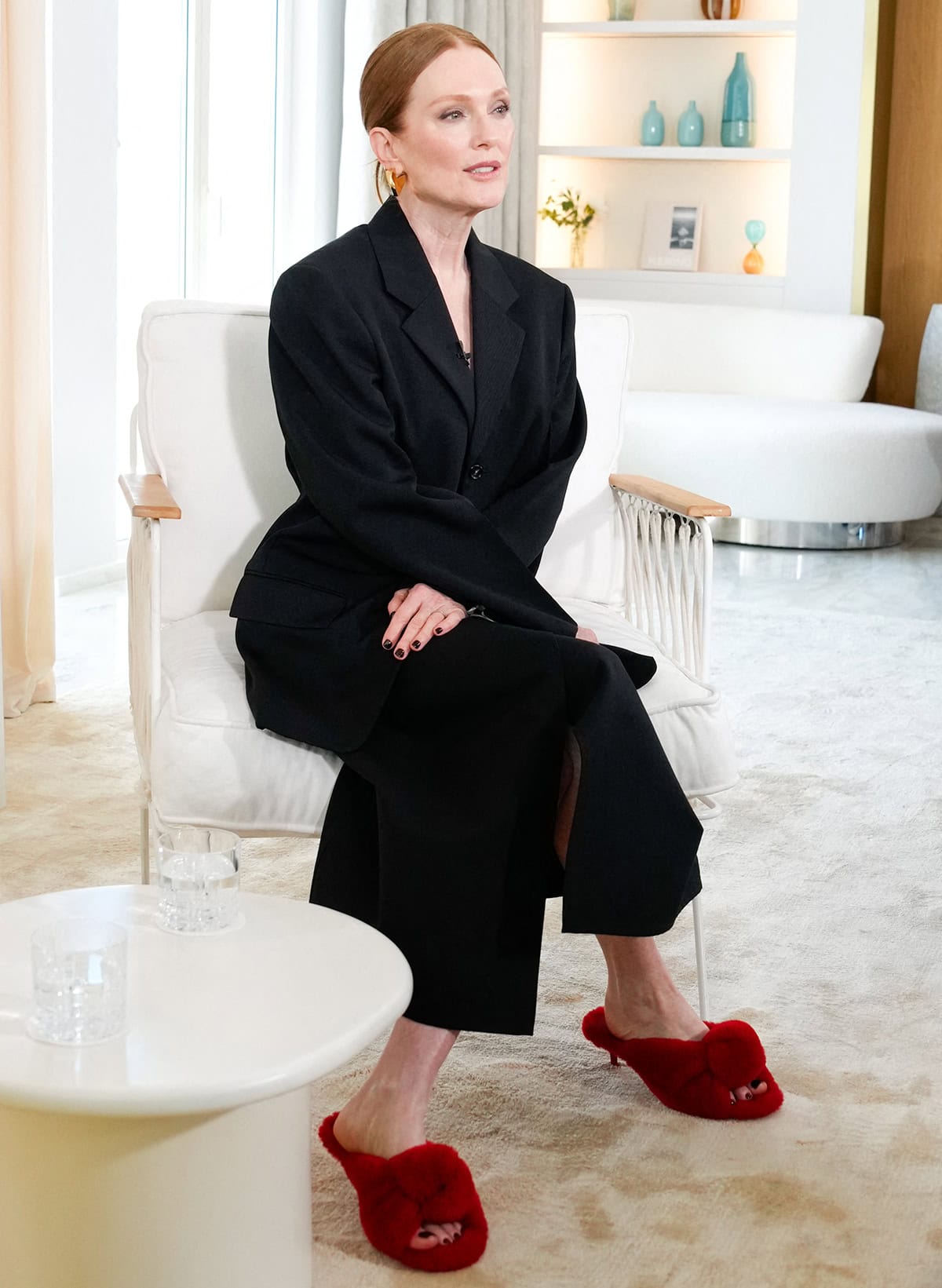 Julianne Moore makes a statement with her fluffy red Bottega Veneta mules and oversized black skirt suit at the Kering Women in Motion: Julianne Moore photocall during the 79th annual Cannes Film Festival at the Carlton Hotel