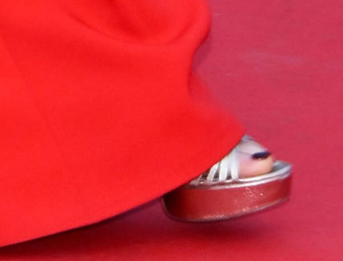 Julianne Moore showcases her pedicure in metallic champagne Loeffler Randall “Rivka” sandals featuring a strappy caged front, platforms, and block heels