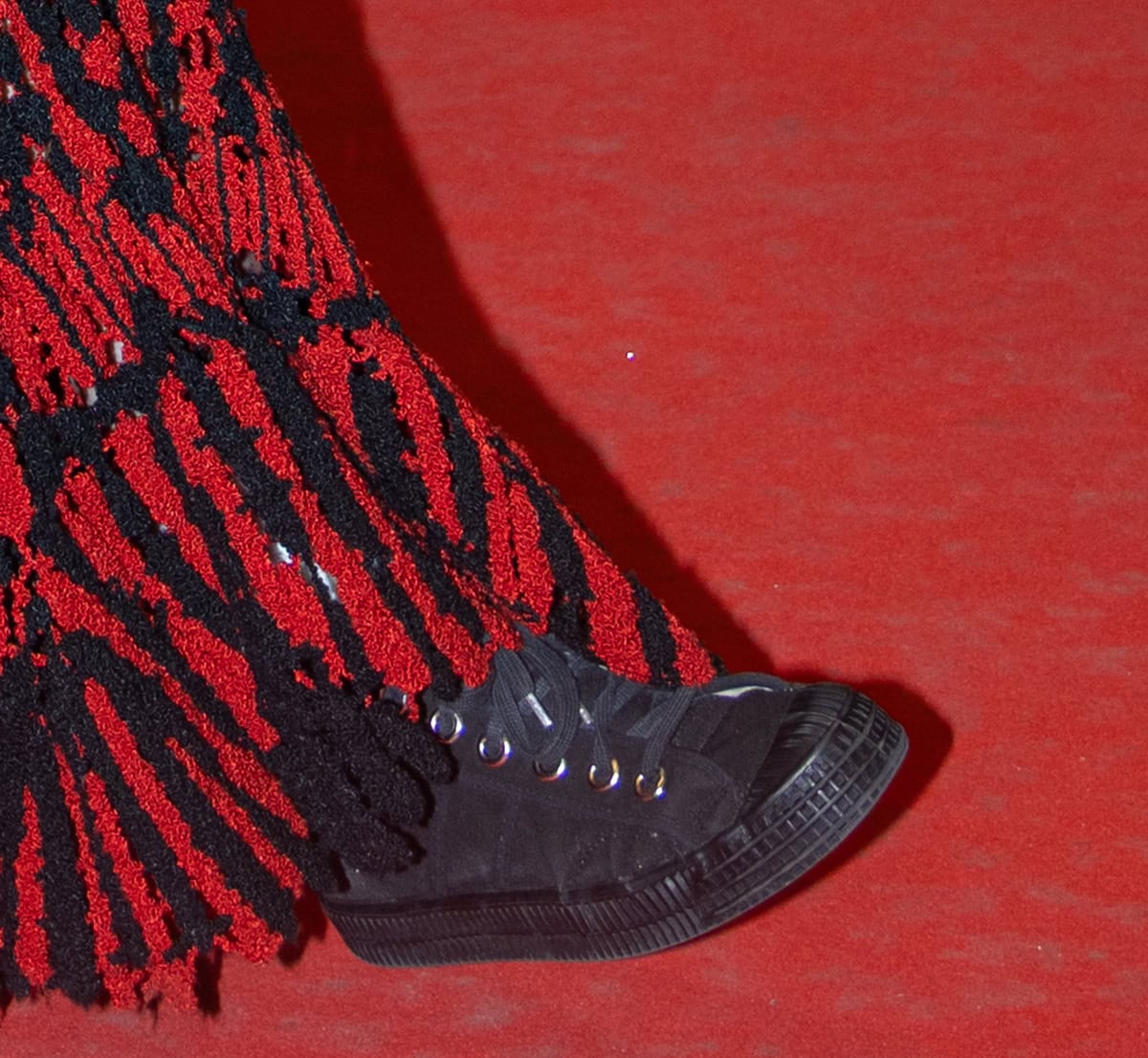 Kristen Stewart wears a pair of black canvas mid-cut sneakers by Ruby Brown with rubber toe caps and soles