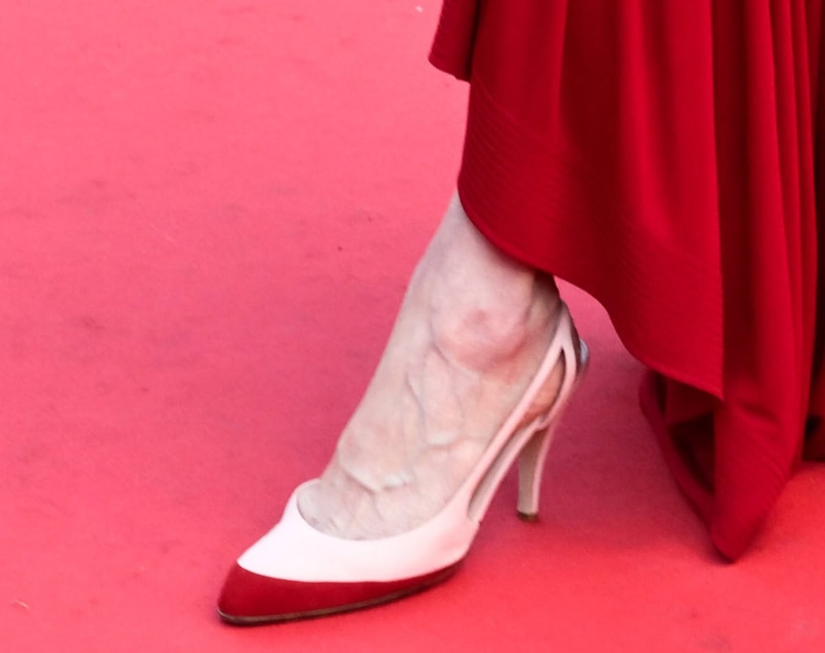 Tilda Swinton slips her feet into Chanel's two-tone cream and red slingback pumps with side cutouts
