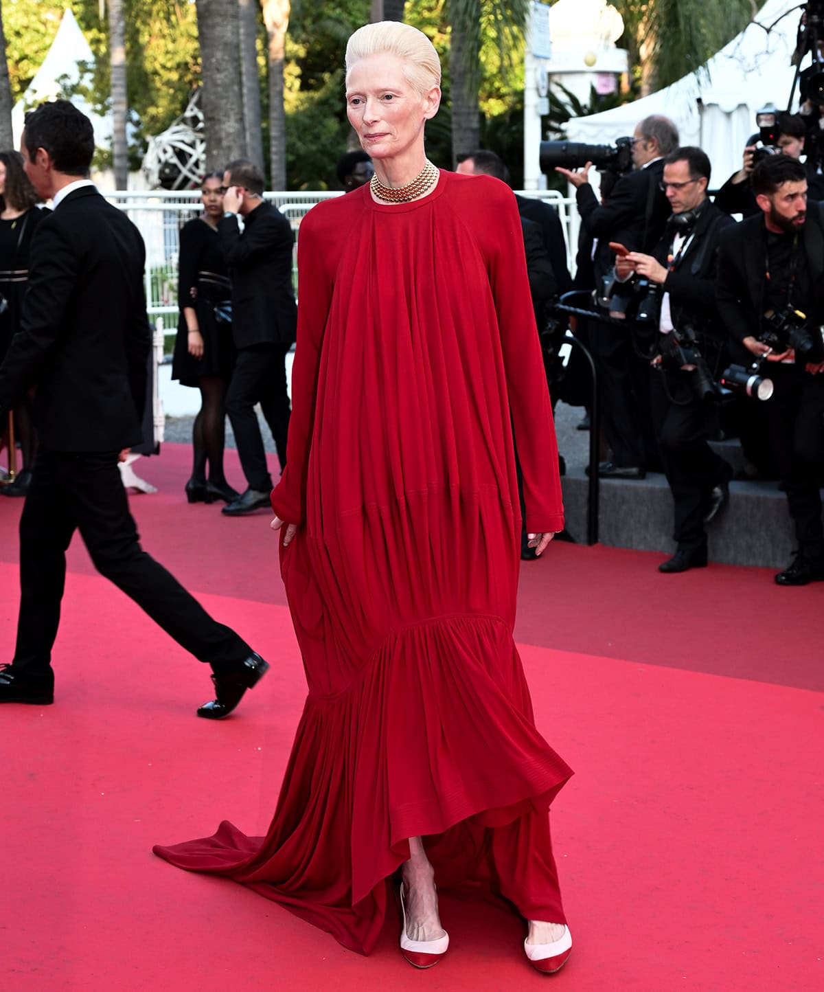 Tilda Swinton keeps her look cohesive by pairing her red-dipped pumps with a sculptural red Chanel gown