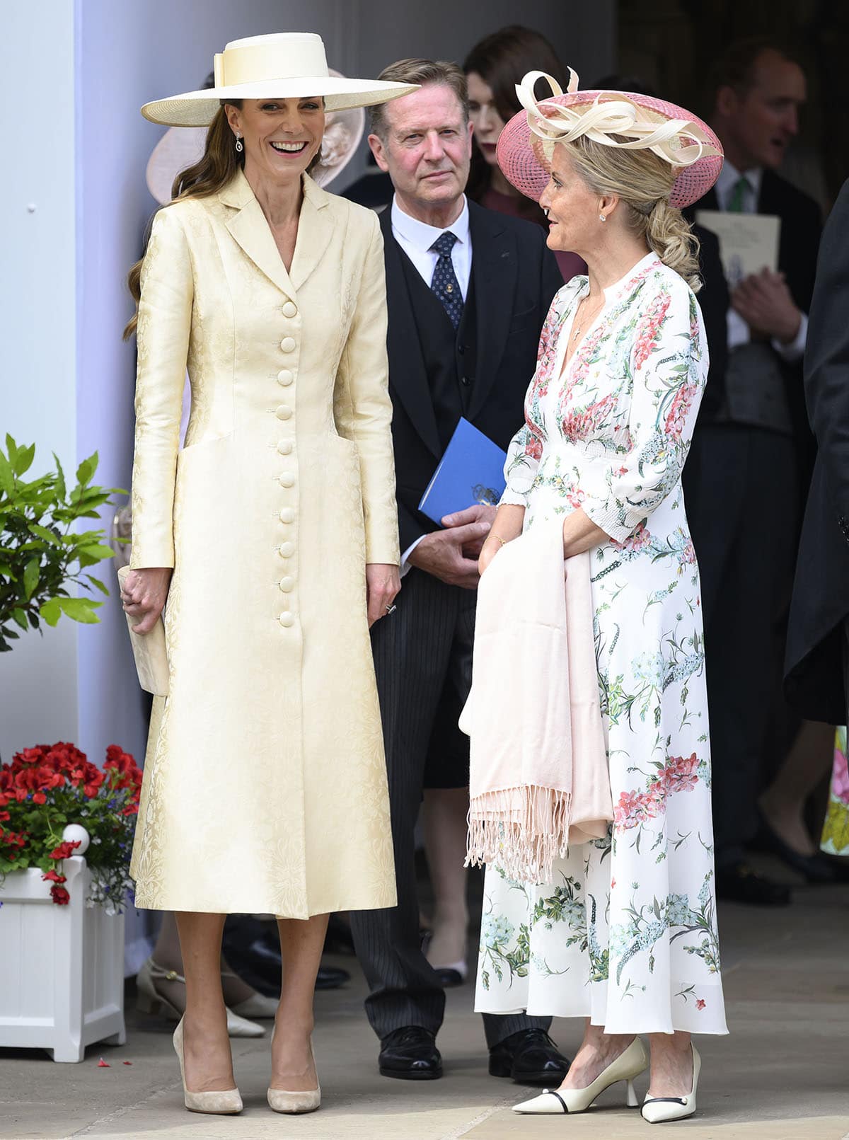 Catherine, Princess of Wales, attends the Order of the Garter Service at Windsor Castle on June 15, 2026, wearing a honey-butter Patrick McDowell silk damask coat dress, her signature Gianvito Rossi "Gianvito 105" suede pumps in bisque, and a cream Jane Taylor boater hat, while Sophie, Duchess of Edinburgh, complements the occasion in a floral dress and cap-toe pumps