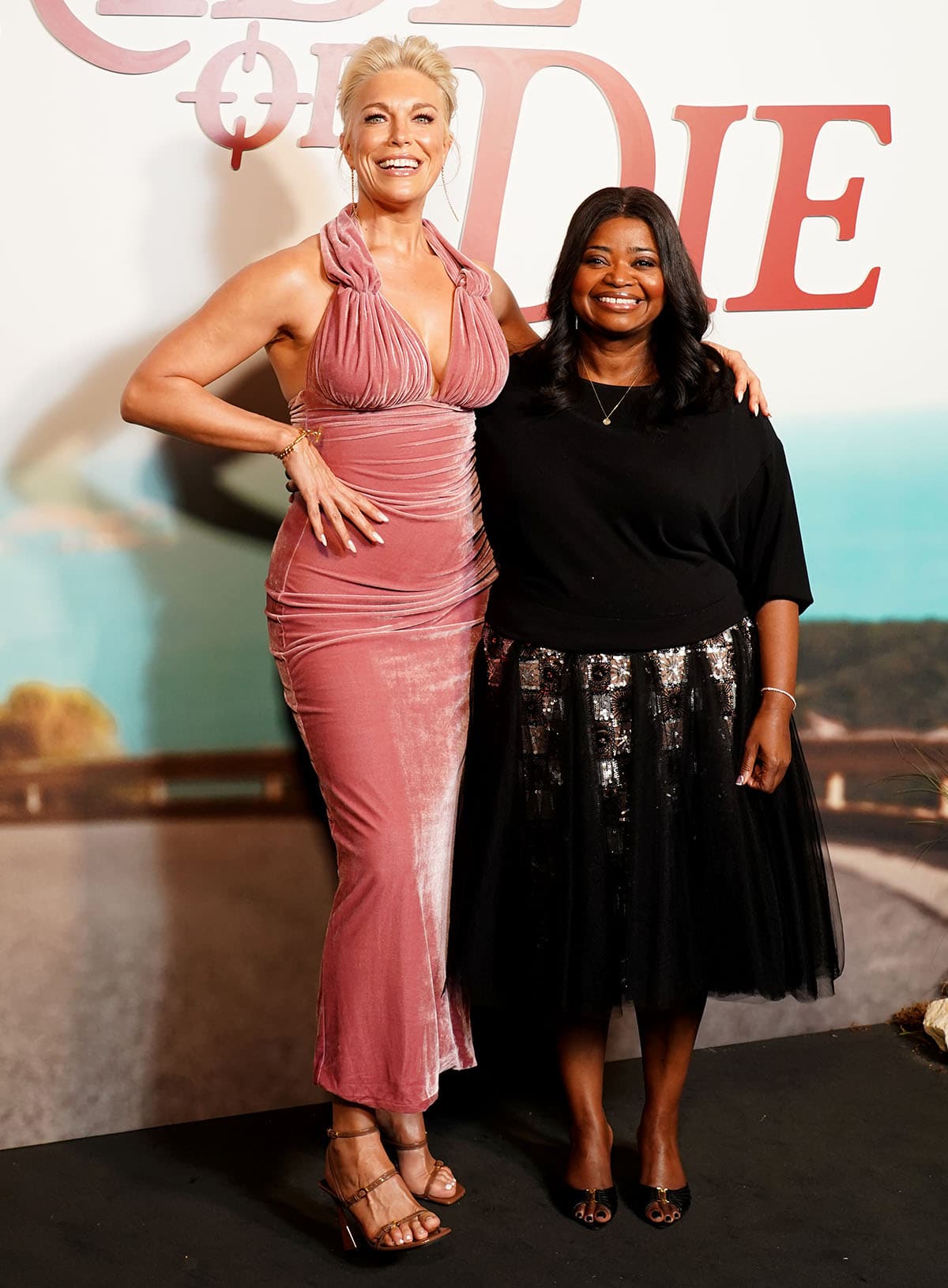 Hannah Waddingham, in a pink velvet halter gown and brown Stella McCartney "Elsa" sandals, stands beside Octavia Spencer, who paired Saint Laurent "Babylone" mules with a black sequined tulle skirt, at the UK special screening of Ride or Die held at the Ham Yard Hotel on June 22, 2026, in London, England