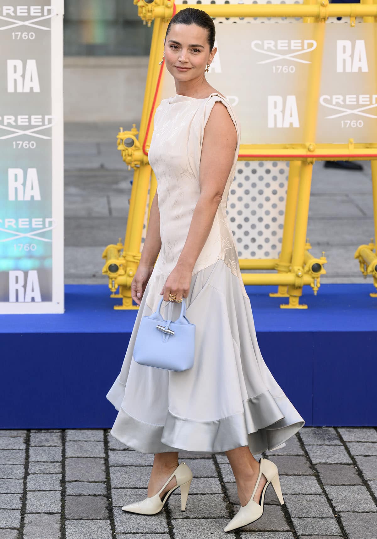 Jenna Coleman pairs her cream pumps with a mixed-media Lanvin dress featuring a pale cream textured bodice and a fluid dove-gray silk skirt
