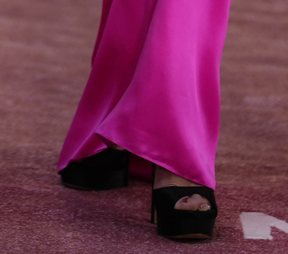 Jennifer Lopez towers in Jimmy Choo's “Max” sandals featuring peep toes, thick platforms, and towering heels