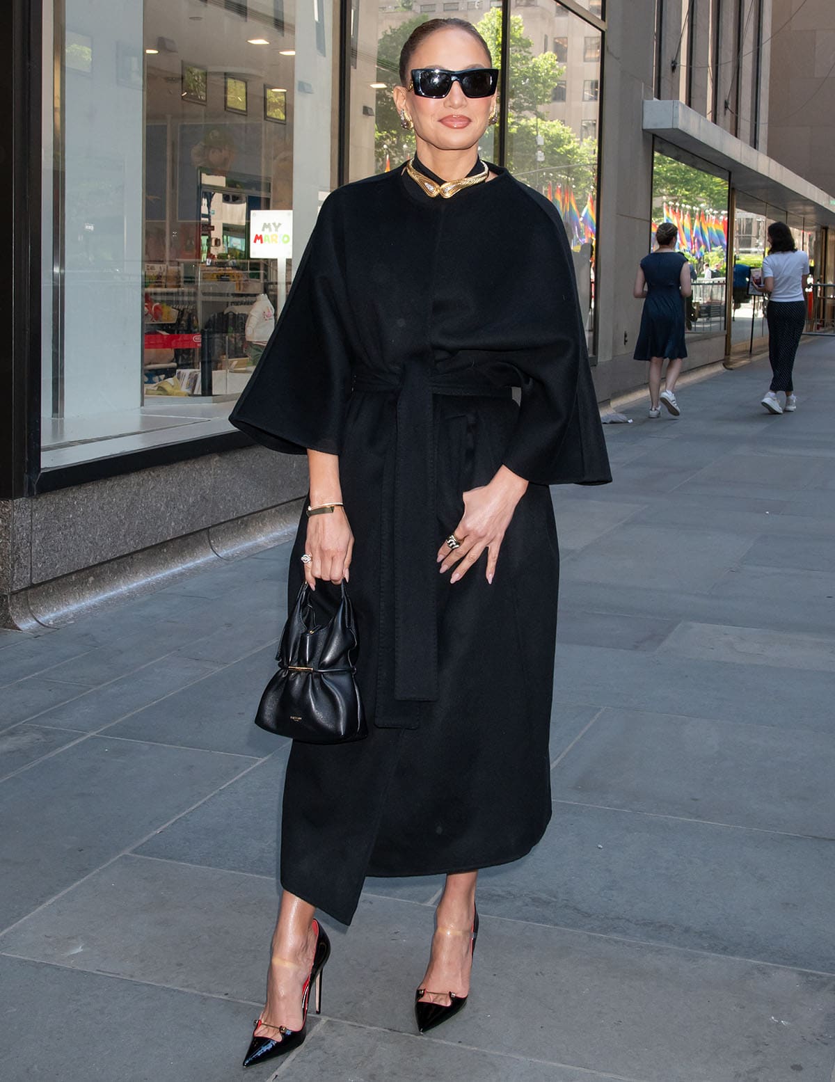 Jennifer Lopez embraces an understated, monochromatic black look, pairing her pumps with a black collarless double-faced cashmere belted coat by Auter, for her CBS Mornings appearance