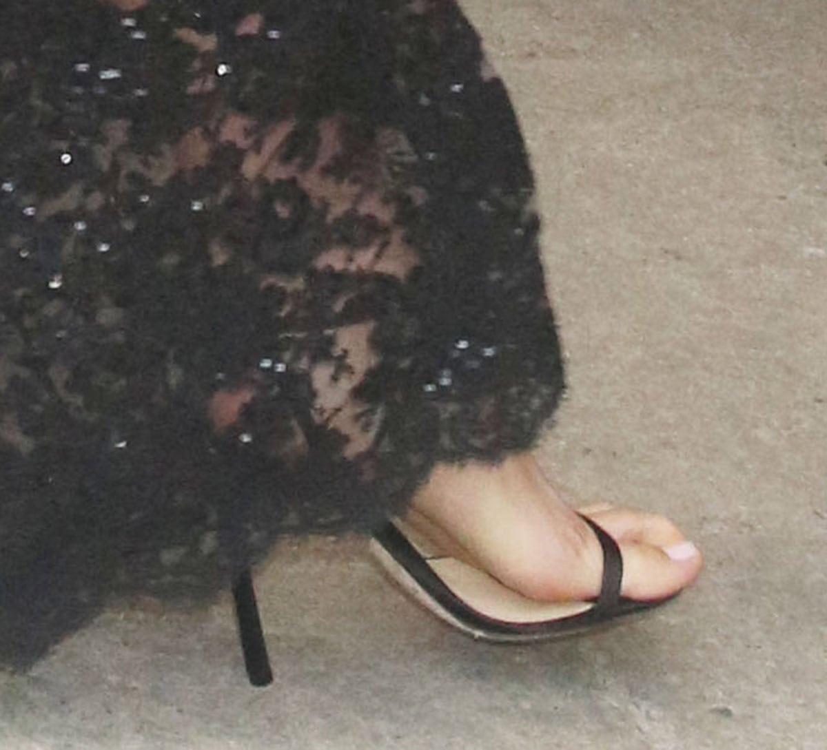 Jodie Comer keeps her footwear simple, wearing minimalist sandals with open toes, slim ankle straps, and stiletto heels