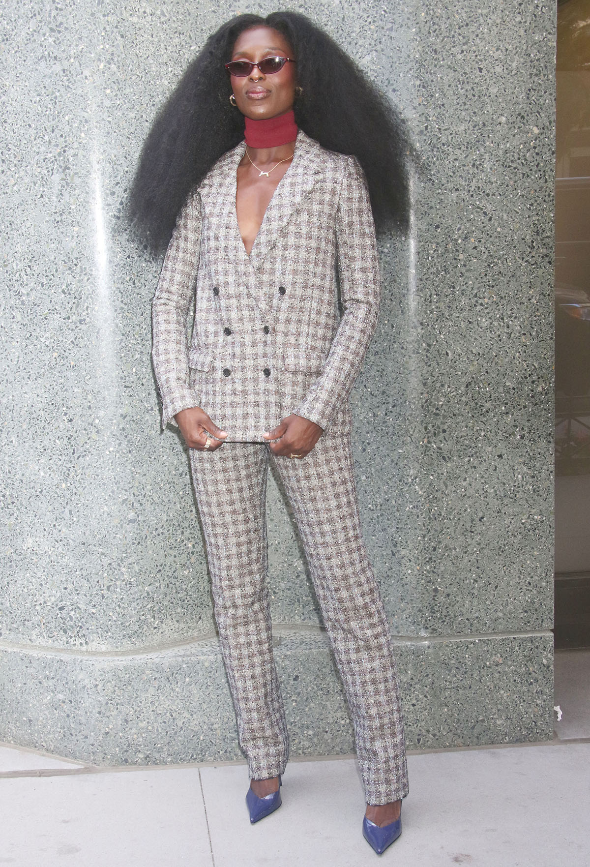 Jodie Turner-Smith pairs her standout pumps with a gray-and-brown plaid tweed Marc Jacobs suit