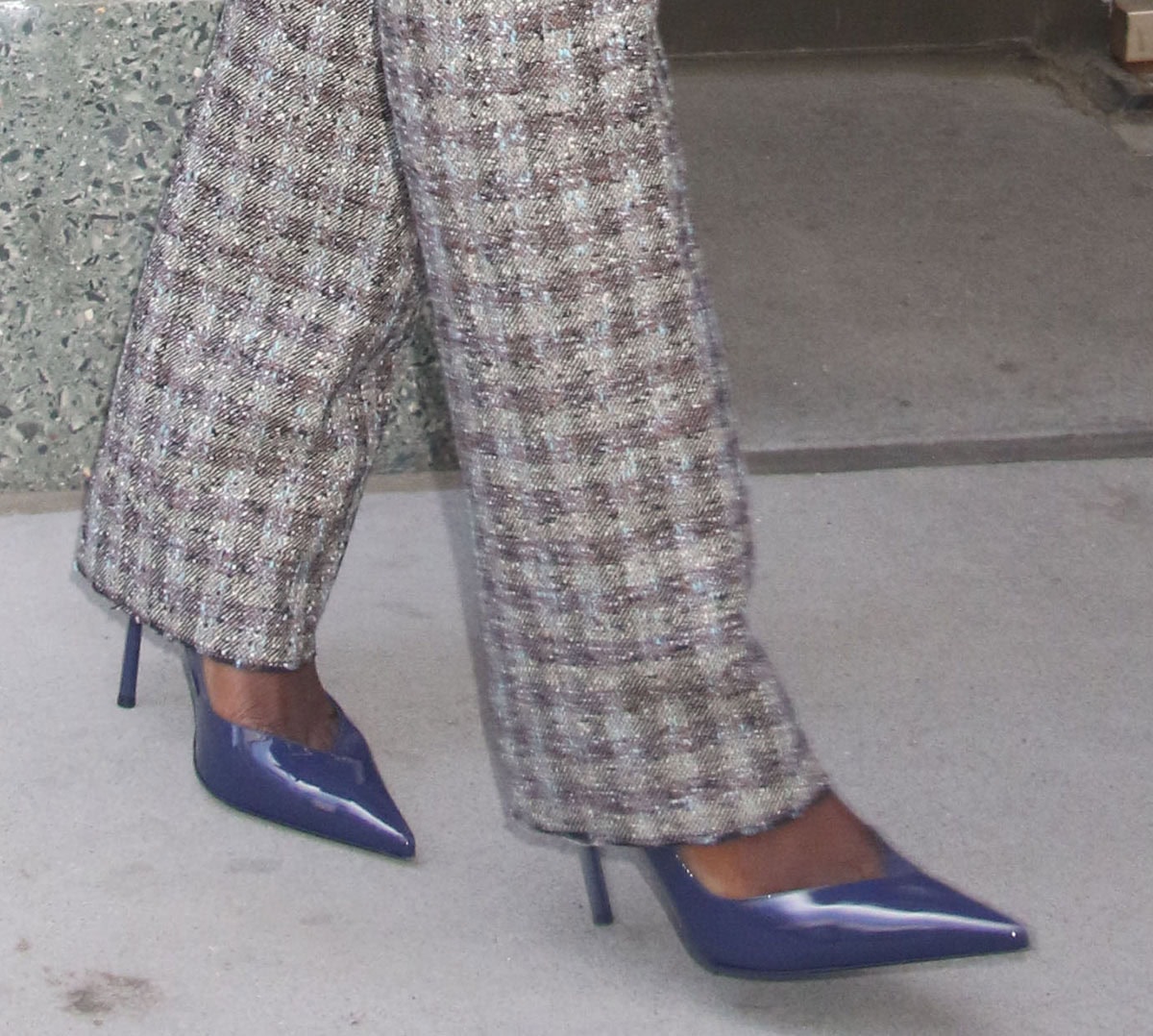 Jodie Turner-Smith slips into the architectural Le Silla “Vivienne” pumps in a striking color with V-shaped vamps, pointed toes, and geometric, razor-thin pin heels