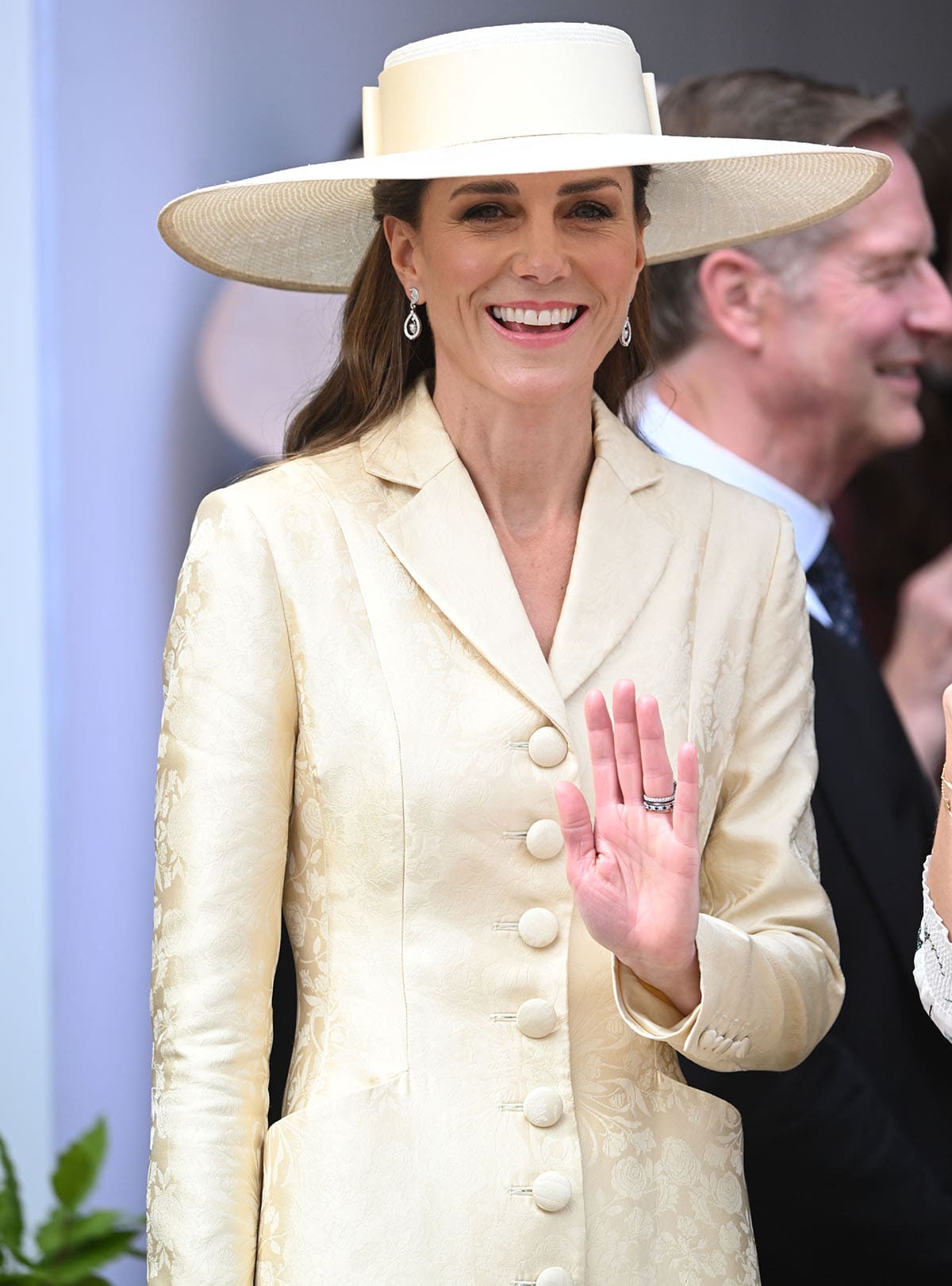 Kate Middleton completes her regal look with a cream Jane Taylor Enid Boater hat in straw, Robinson Pelham earrings, and a few heritage rings