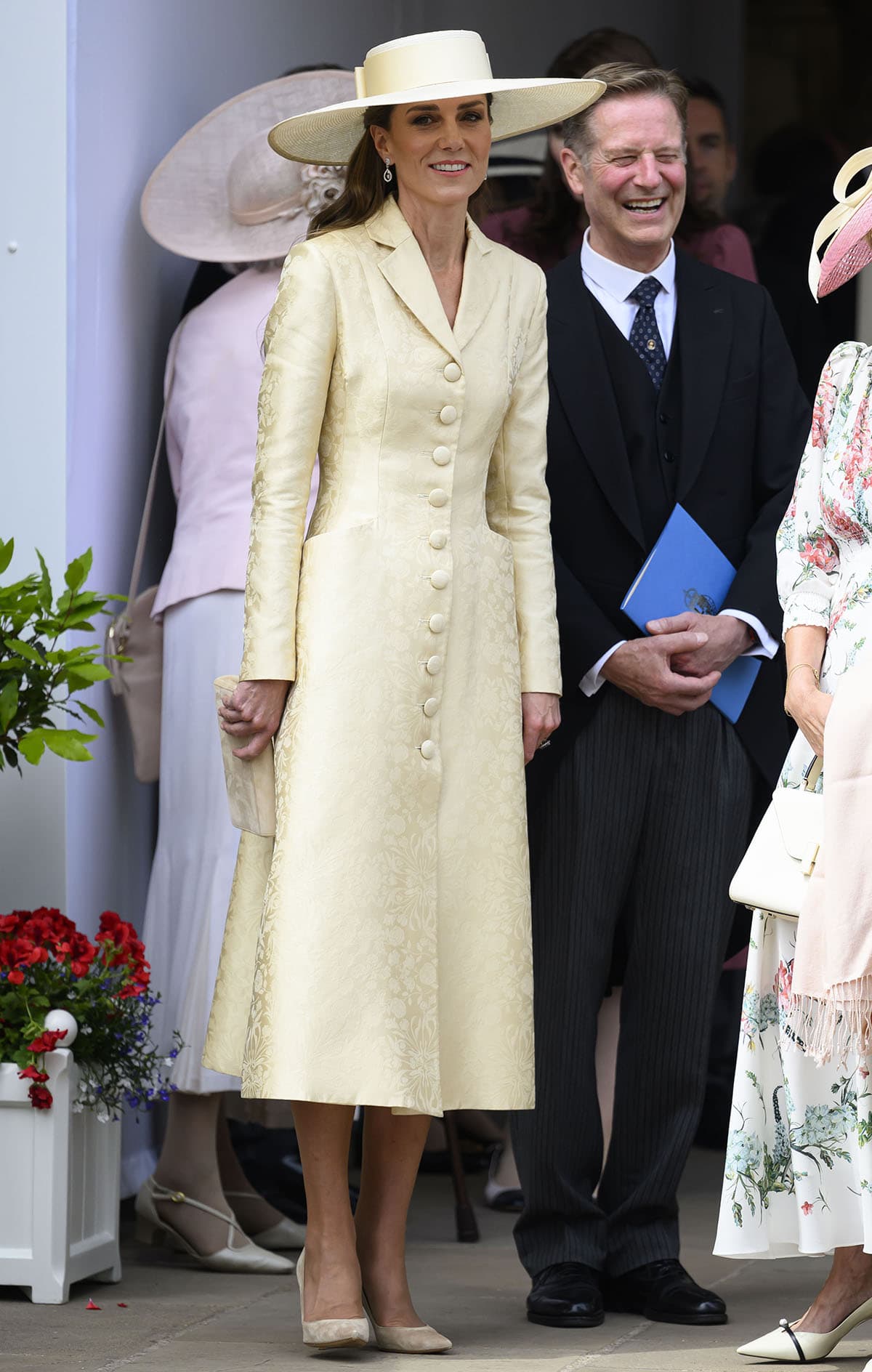 Kate Middleton pairs her pumps with a honey-butter yellow Patrick McDowell coat dress made from an English rose silk damask woven by Stephen Walters and Sons