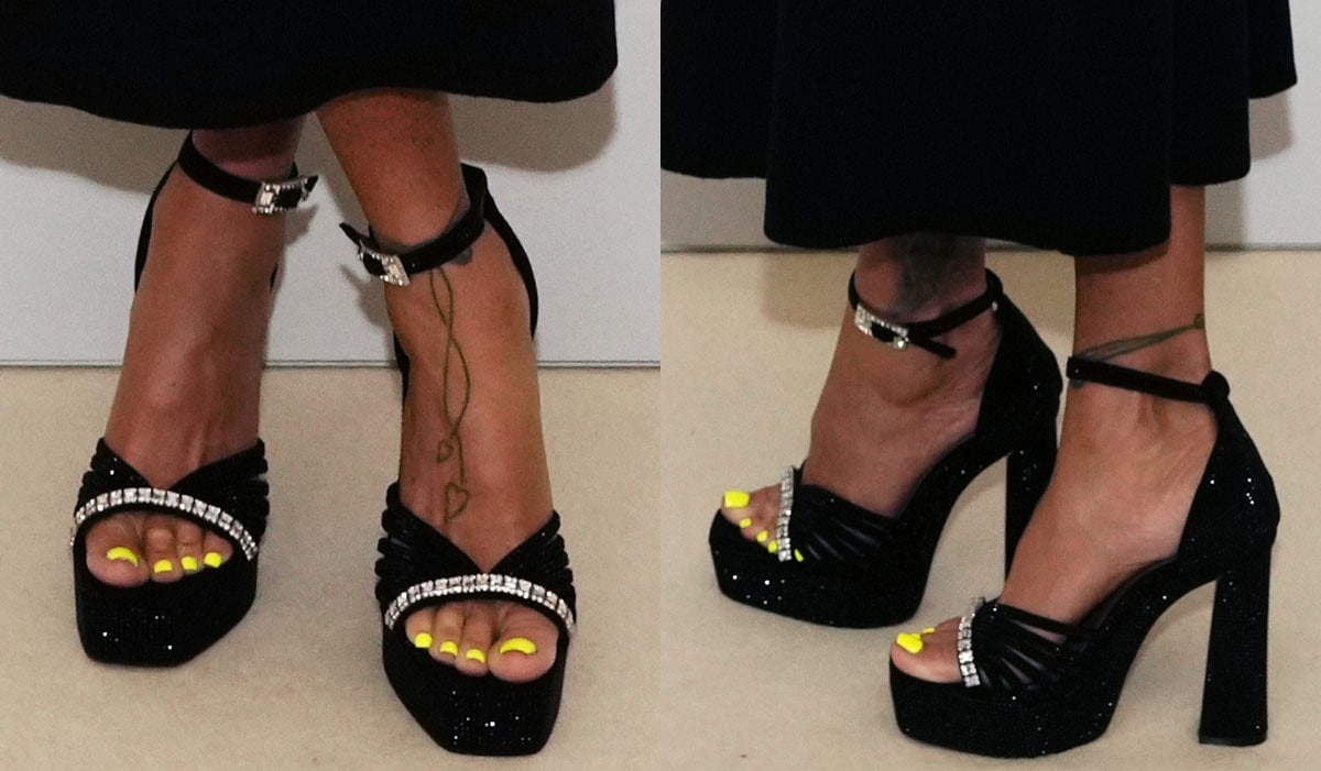 Katie Price showcases her neon yellow pedicure in the black crystal-embellished strappy sandals by Kurt Geiger featuring clear crystals across the toes, ankle straps with a large crystal buckle, chunky platforms, and block heels