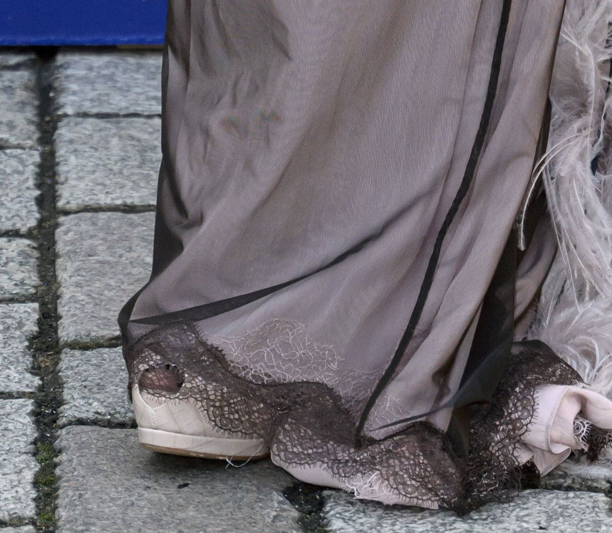 Lily Allen offers a rare glimpse of her Giuseppe Zanotti “Sharon” pumps, showcasing the style’s cream croc-embossed leather, peep-toe silhouette, hidden platforms, and sky-high heels beneath her sweeping gown
