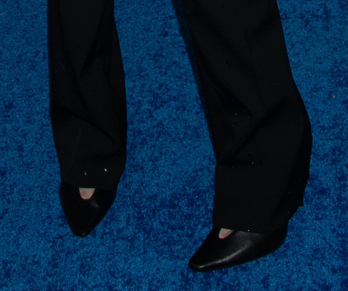 Milly Alcock wears the Balenciaga “Duchesse” glove pumps with asymmetrical pointed toes, high-cut topline, and deep V-neck vamps