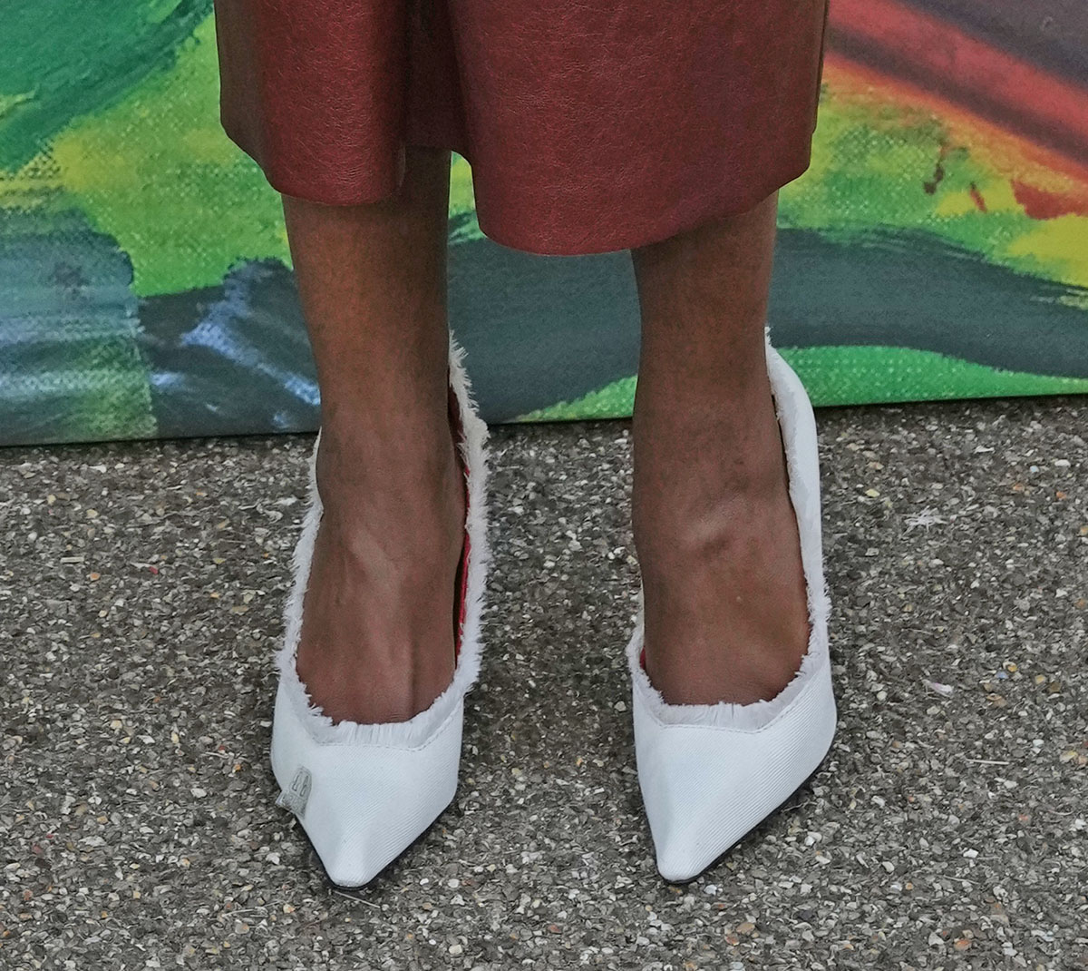 Naomie Harris opts for the white Ferrari Canvas pumps with pointed toes, squared vamps, and a frayed topline