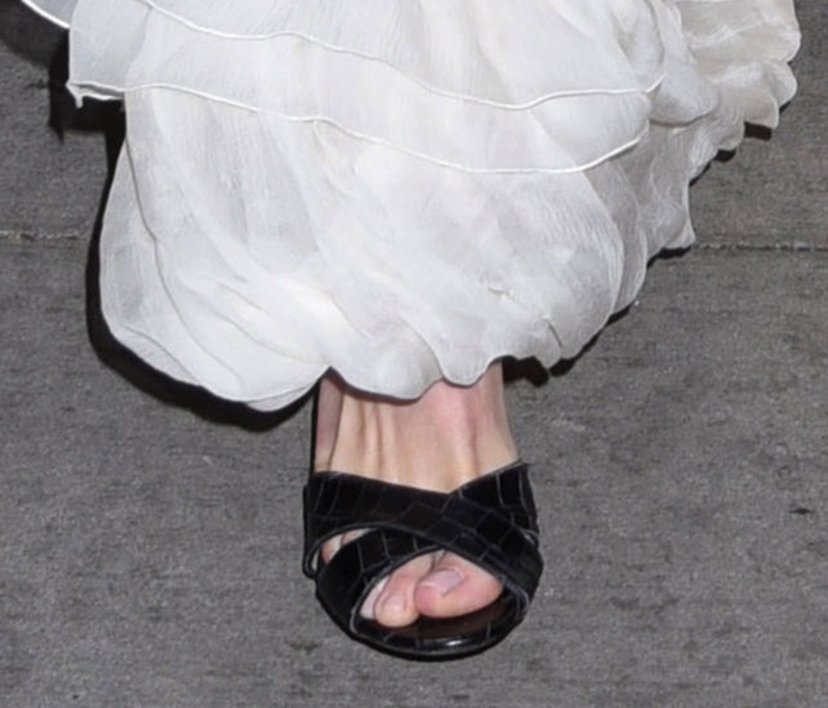 Olivia Wilde slips into the Giuseppe Zanotti “Felicia” mules featuring crisscrossing front straps in black croc-effect leather