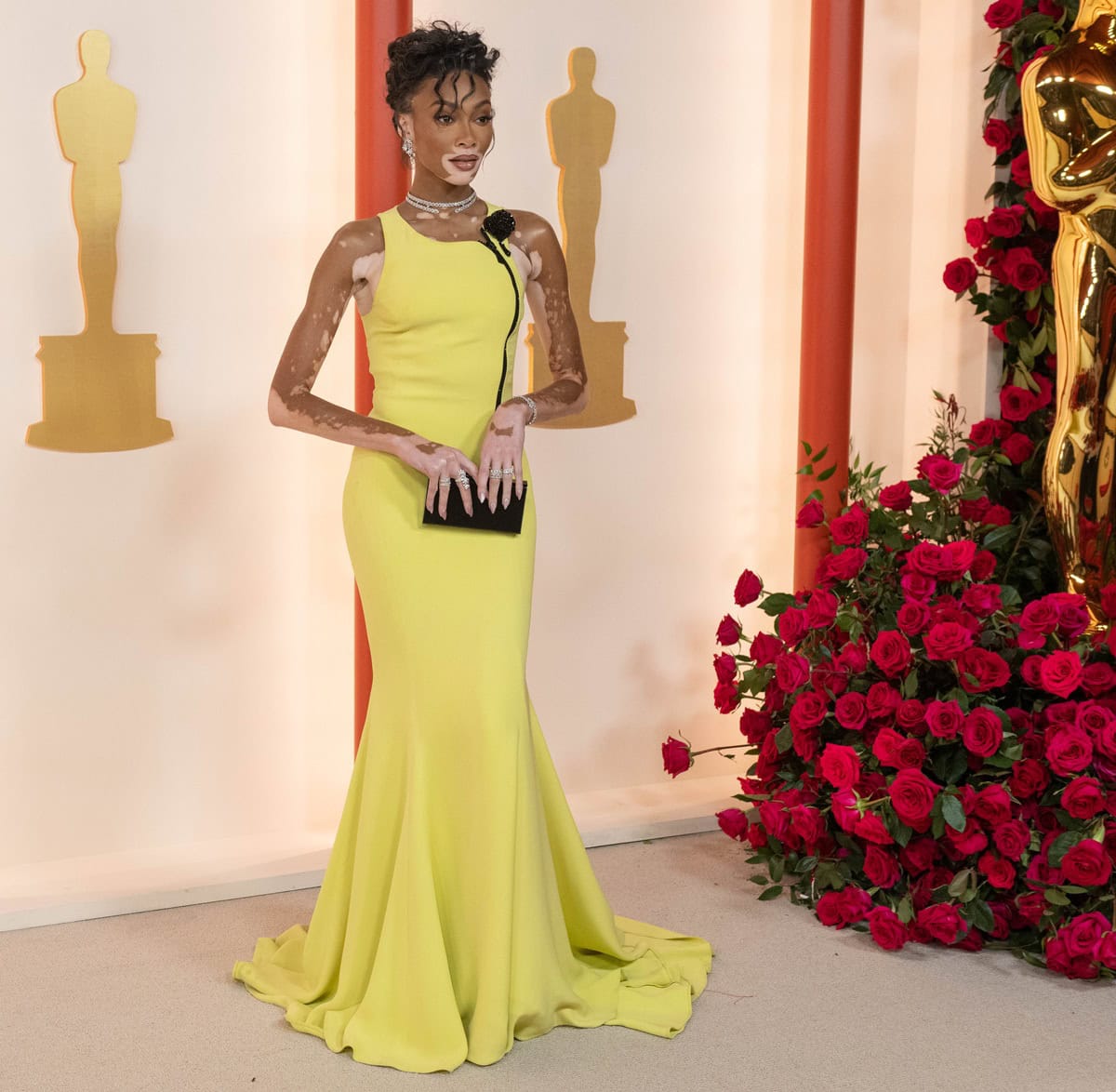 Winnie Harlow brought a dramatic pop of color to the 95th Academy Awards, pairing a vintage butter-yellow Giorgio Armani Privé couture gown with black crystal-embellished Alexandre Birman Martina sandals