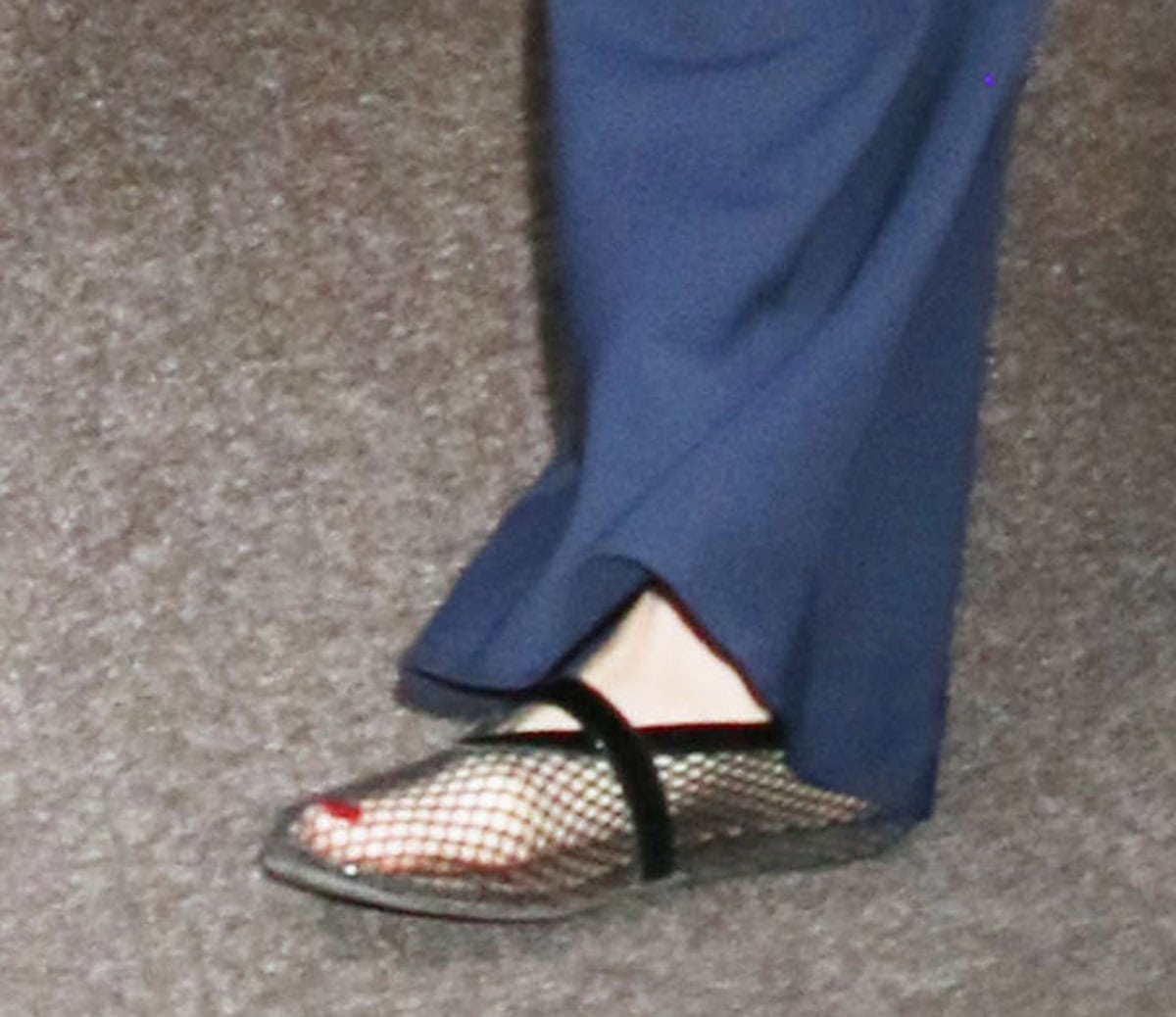 Pregnant Anne Hathaway keeps things comfy in a pair of Alaïa mesh ballet flats featuring a fishnet mesh upper and glossy patent calfskin leather trims