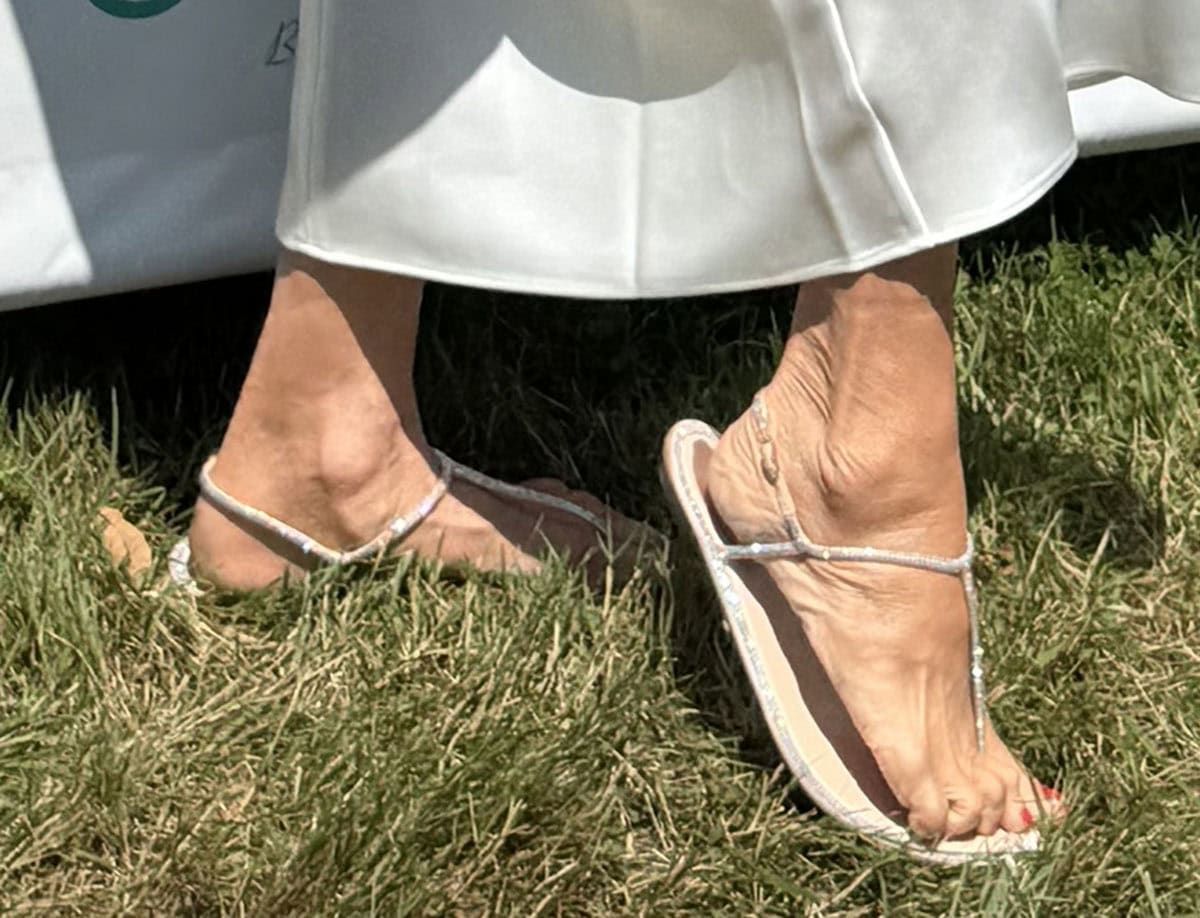 Christie Brinkley embraces chic and comfy summer style in René Caovilla “Diana” thong-style flat sandals featuring shimmering crystal embellishments along the straps and around the insoles