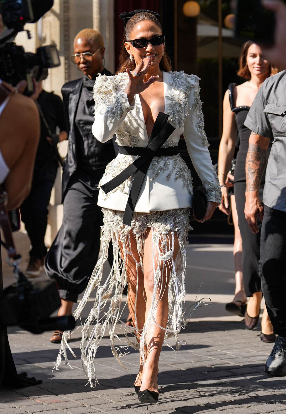 Jennifer Lopez graces the Zuhair Murad Haute Couture Fall/Winter 2026-2027 front row during Paris Fashion Week, wearing a crystal-embellished jacket and skirt from the Lebanese designer and black pumps from Dolce Gabbana