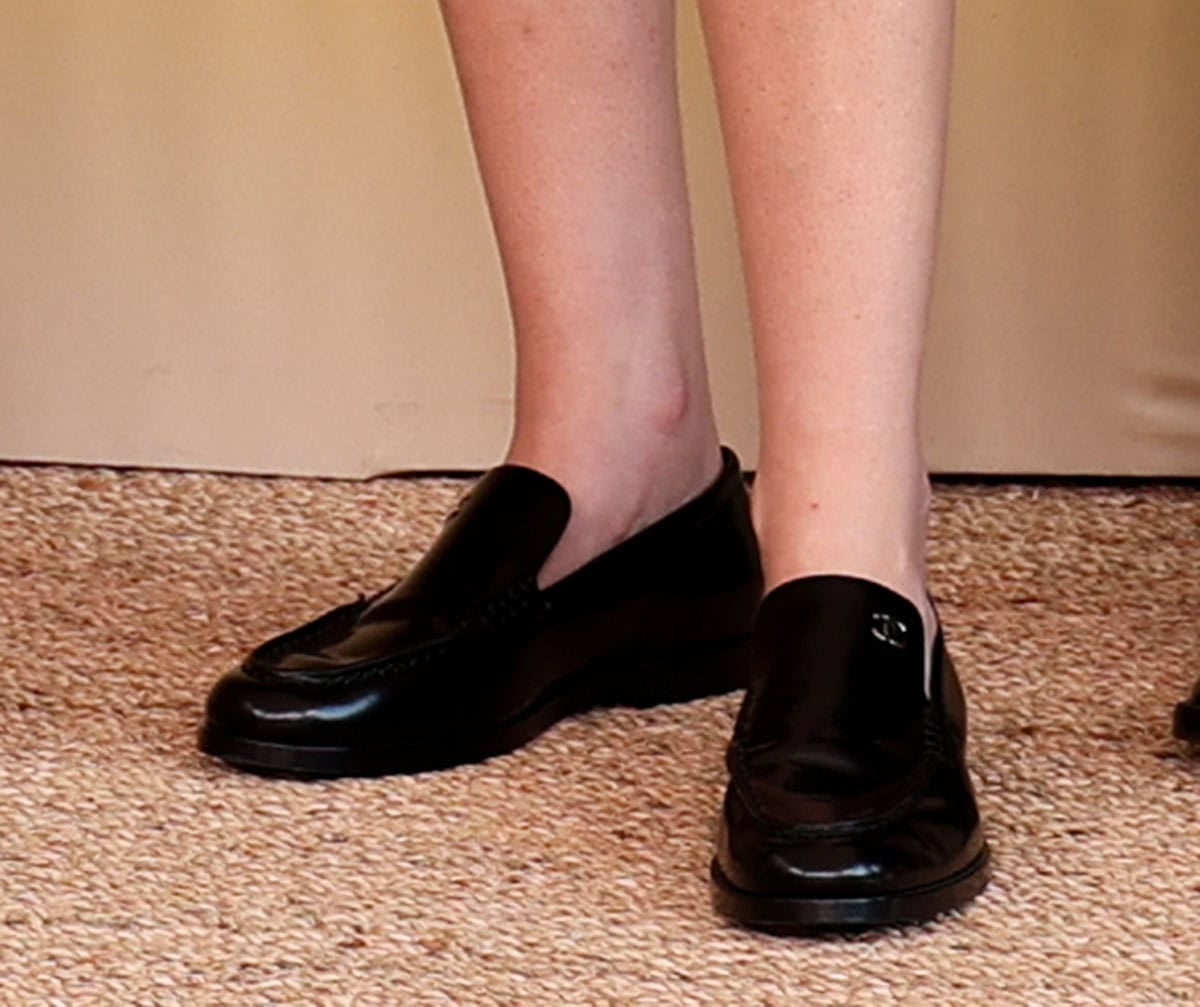 Kristen Stewart gives her tweed suit a preppy edge with Chanel moccasin-style loafers featuring apron stitching and CC logo at the collar edge and heel