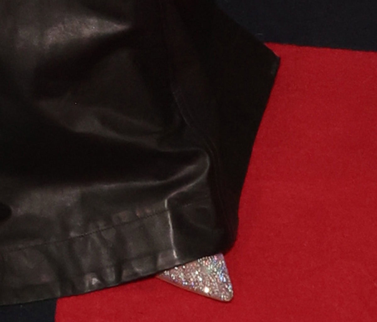 Malia Baker adds sparkle to her dramatic leather ensemble with crystal-embellished pointed-toe pumps