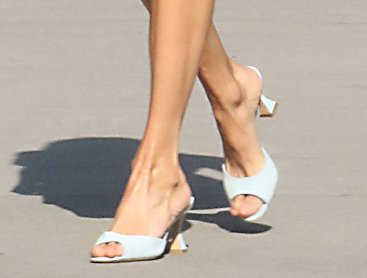 Nina Dobrev slips into the chic and comfy Manolo Blahnik “Jadaron” mules featuring peep toes and pedestal heels that flare at the base