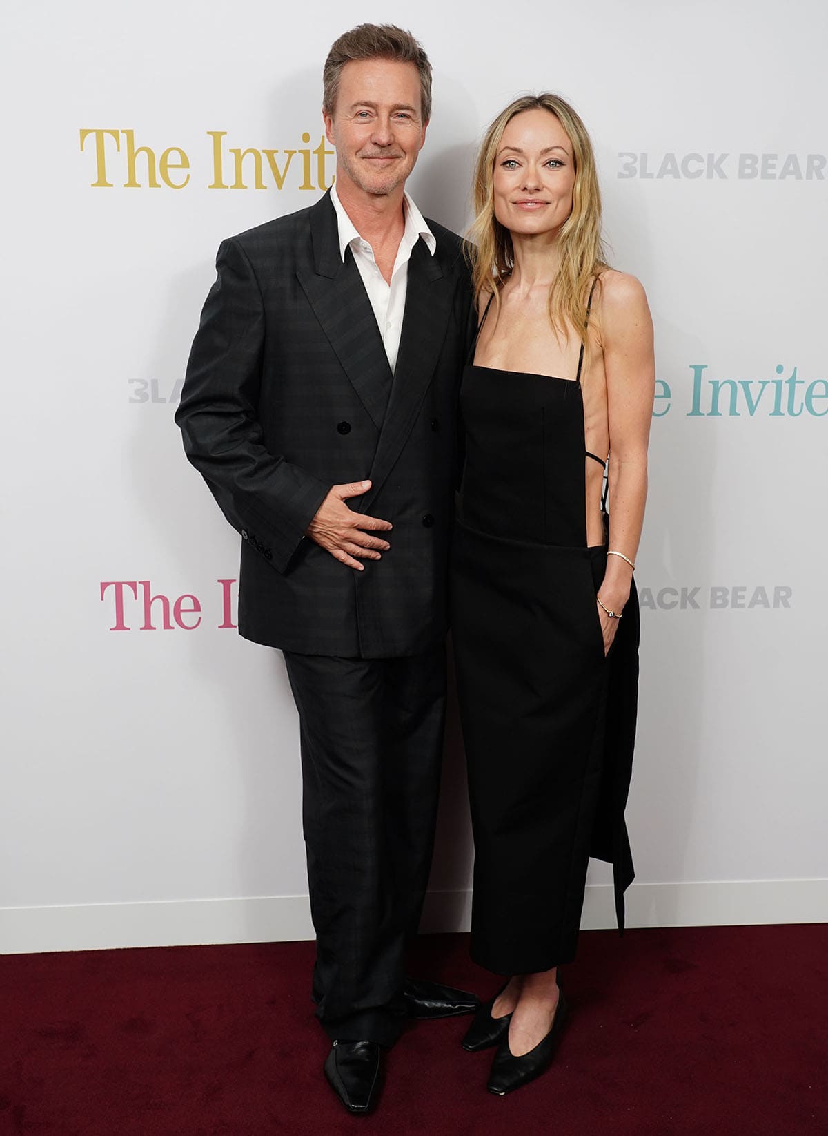Olivia Wilde, with co-star Edward Norton, teams her simple flats with a sophisticated yet sultry LBD by Calvin Klein featuring a square neckline and an open back secured with skinny straps