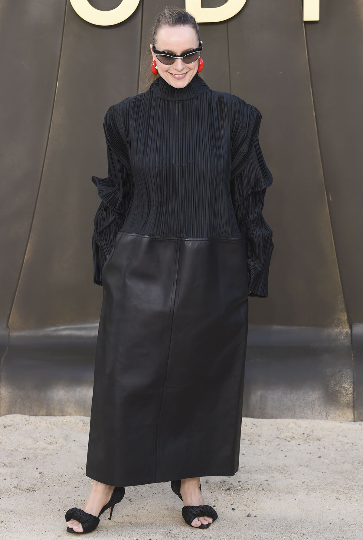 Samantha Morton teams her unique heels with a futuristic Bottega Veneta mixed-media dress featuring a micro-pleated plissé turtleneck top and a heavy, structured matte-black leather maxi skirt