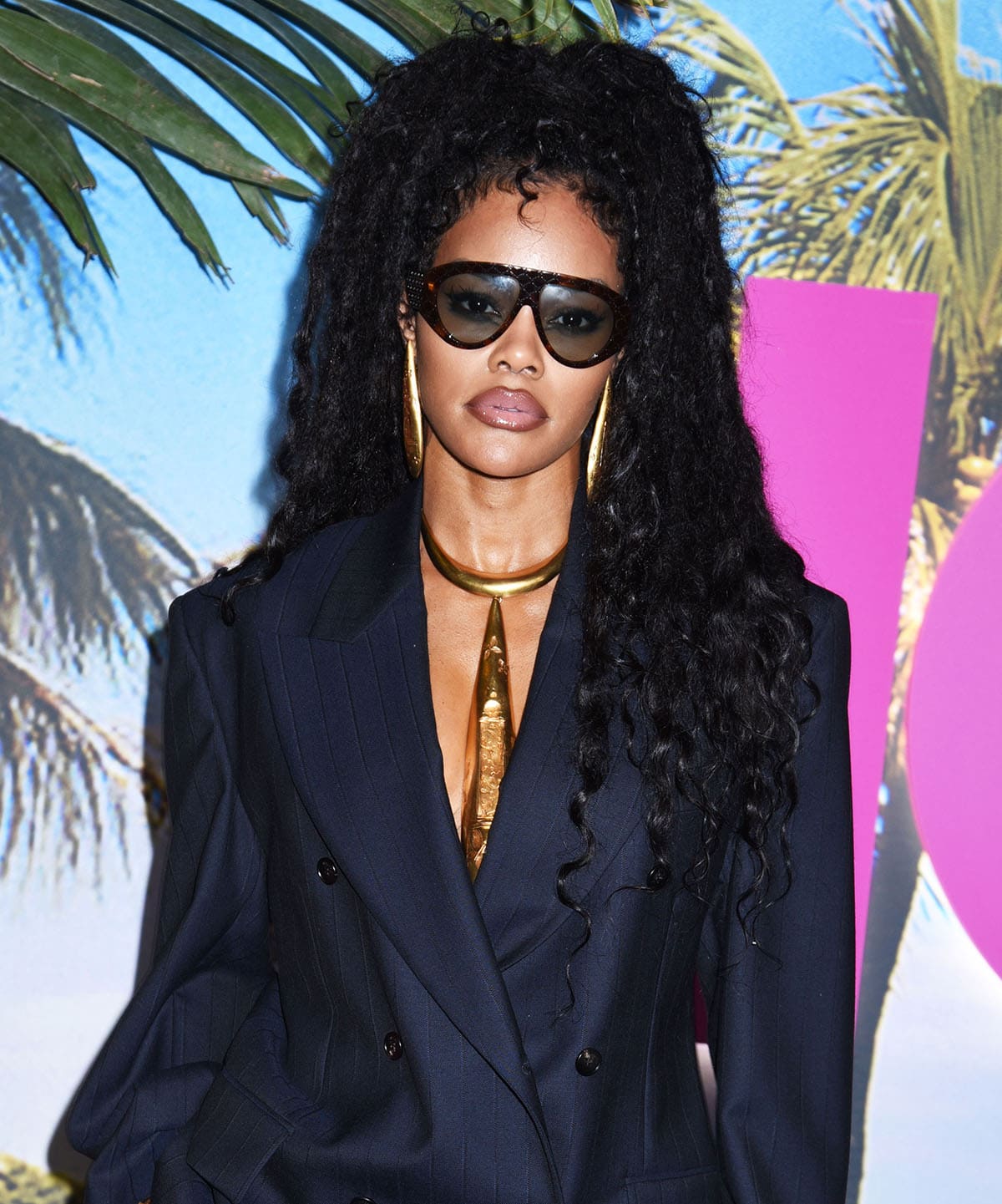 Teyana Taylor teams her cool, modern tailored outfit with Schiaparelli's Vendôme long earrings and matching long necktie-like necklace
