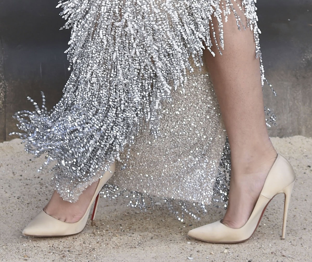 Zendaya completes her Schiaparelli couture look with champagne satin Christian Louboutin “So Kate” pumps featuring sharply pointed toes and towering stiletto heels