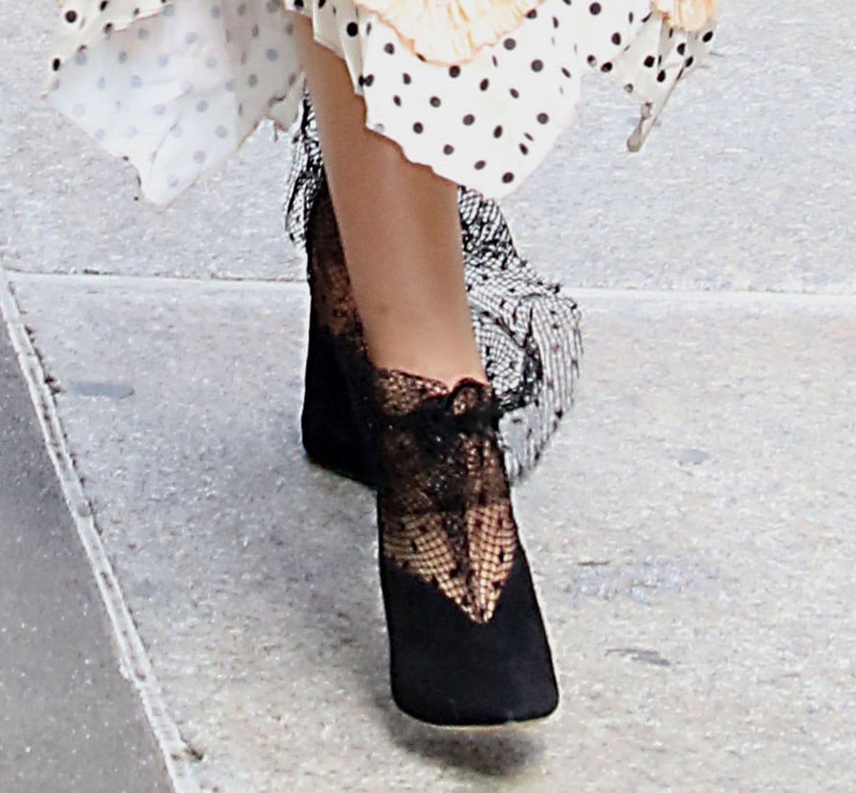Ashtin Earle brings a dose of dark glamour to her press look with Jimmy Choo’s “Leanne” booties, featuring velvet uppers with a high V-cut vamp, pointed toes, and a dotted fishnet panel with a drawstring closure