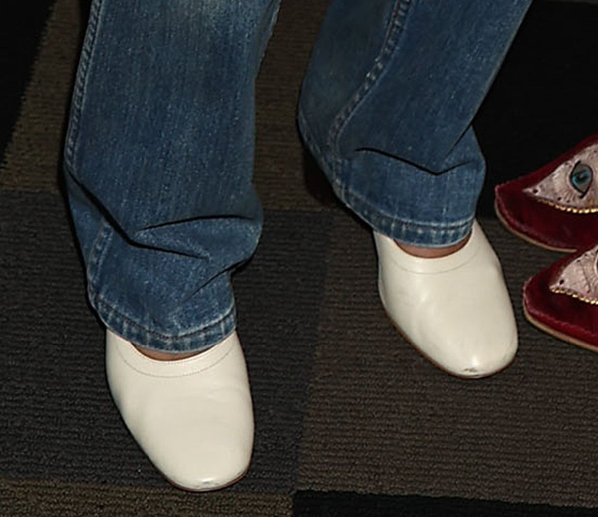 Elise Kibler gives relaxed blue jeans a polished finish with cream leather pumps featuring rounded-square toes, high-cut vamps, and contrasting black heels at the Union County premiere